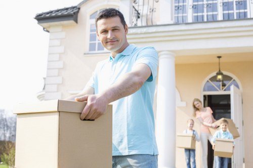 Removal team carrying furniture through a Pinner home