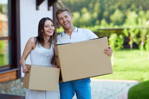 Professional movers packing fragile household items in Pinner