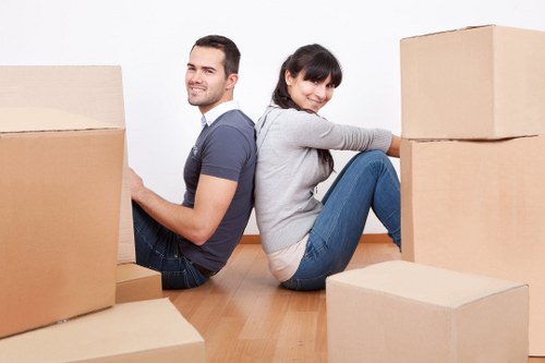 Professional movers carefully handling fragile items during a Pinner relocation